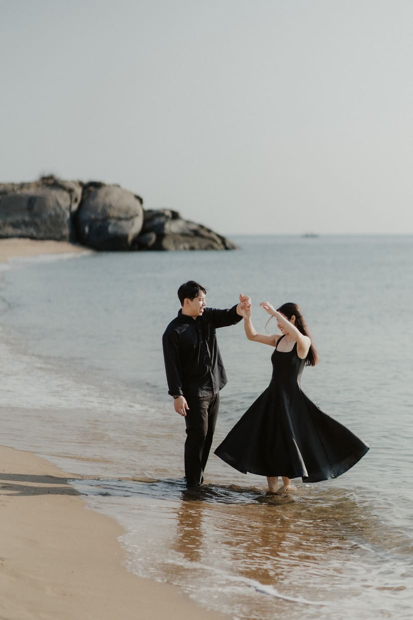 The bride spinning in shallow sea, dress fanned out