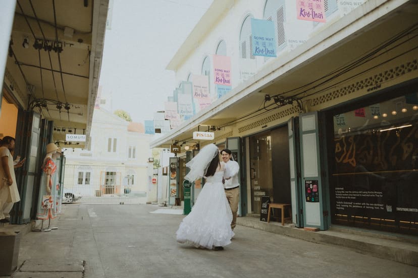 The couple walking side by side in Songwat at dusk